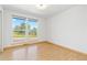 Bright bedroom with large windows offering scenic views and hardwood floors at 310 S Alkire St, Lakewood, CO 80228