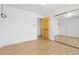 Bedroom with closet, door, and laminate wood flooring at 310 S Alkire St, Lakewood, CO 80228