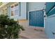 Inviting front entrance with a stylish blue door and decorative landscaping at 310 S Alkire St, Lakewood, CO 80228