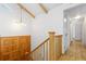 Hallway and stairwell area with wood flooring, light fixtures, and wooden doors at 310 S Alkire St, Lakewood, CO 80228