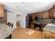 Well-lit kitchen with dark appliances, granite counters, and a breakfast bar at 310 S Alkire St, Lakewood, CO 80228