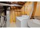 Laundry room with exposed pipes and a washer and dryer at 310 S Alkire St, Lakewood, CO 80228