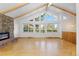 Open-concept living room with high ceilings, exposed beams, and large windows offering scenic views at 310 S Alkire St, Lakewood, CO 80228