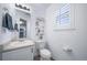 Bright half bath featuring modern fixtures, including a framed mirror and a small plant for decor at 12069 Monaco Ct, Brighton, CO 80602