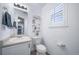 Well-lit half bathroom with a decorative painting and modern fixtures at 12069 Monaco Ct, Brighton, CO 80602