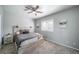 This bedroom features a ceiling fan and a decorative headboard and side table set at 12069 Monaco Ct, Brighton, CO 80602