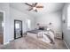 The bedroom features a neutral color scheme and a large mirror at 12069 Monaco Ct, Brighton, CO 80602