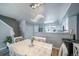Dining room with stylish lighting, an open view into the kitchen, and modern white furnishings at 12069 Monaco Ct, Brighton, CO 80602