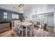 Dining room has stylish chandelier, white table set, accent wall, and beverage cooler at 12069 Monaco Ct, Brighton, CO 80602