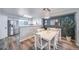 Bright dining area with modern chandelier and a view into the kitchen at 12069 Monaco Ct, Brighton, CO 80602