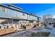 Charming blue townhomes feature stone accents, a quaint fence, and well-maintained landscaping at 12069 Monaco Ct, Brighton, CO 80602