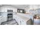 Spacious kitchen with white cabinets, countertops, modern appliances, and an adjacent dining area at 12069 Monaco Ct, Brighton, CO 80602