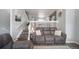 Cozy living room with comfortable seating and staircase at 12069 Monaco Ct, Brighton, CO 80602