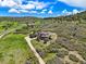 Aerial view of a luxury home nestled amongst trees, showcasing the surrounding landscape and driveway at 4222 Serenade Rd, Castle Rock, CO 80104