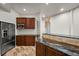 Bar area showcasing dark wood cabinets, marble countertops, and stainless steel appliances at 4222 Serenade Rd, Castle Rock, CO 80104