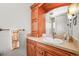 Well-lit bathroom with wood cabinet and tile countertop at 4222 Serenade Rd, Castle Rock, CO 80104