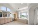 Spacious bathroom with double vanity, soaking tub, and arched window overlooking the landscape at 4222 Serenade Rd, Castle Rock, CO 80104