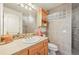 Neutral bathroom with a single vanity, tiled walls, and glass block window for natural light at 4222 Serenade Rd, Castle Rock, CO 80104