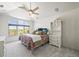 Cozy bedroom with plush carpet, colorful bedding, and a large arched window with scenic views at 4222 Serenade Rd, Castle Rock, CO 80104