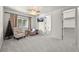 Cozy bedroom with ceiling fan, sitting area, and easy access to bathroom and closet at 4222 Serenade Rd, Castle Rock, CO 80104