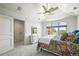 Bright bedroom featuring a floral-patterned bed, large window with a view, and access to closet at 4222 Serenade Rd, Castle Rock, CO 80104