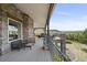 Covered deck with stone pillars, railings and outdoor furniture at 4222 Serenade Rd, Castle Rock, CO 80104