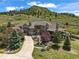 Stunning stone home with manicured landscaping and a circular driveway, set against a beautiful mountain backdrop at 4222 Serenade Rd, Castle Rock, CO 80104