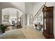 Elegant foyer with tiled floors, a staircase with iron railings, and a view into the living room with a fireplace at 4222 Serenade Rd, Castle Rock, CO 80104