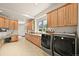 Large laundry room with updated appliances, ample storage, and desk area at 4222 Serenade Rd, Castle Rock, CO 80104