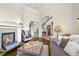 Cozy living room showcasing a fireplace, comfortable seating, and views into the foyer with a staircase at 4222 Serenade Rd, Castle Rock, CO 80104