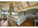 Bright living room showcasing a stone fireplace, built-in shelving, and large windows with picturesque views at 4222 Serenade Rd, Castle Rock, CO 80104
