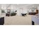 A large living room with a stone fireplace, bar area, and game tables for entertainment at 4222 Serenade Rd, Castle Rock, CO 80104