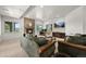 Bright living room features a stone fireplace, large windows and a TV at 4222 Serenade Rd, Castle Rock, CO 80104