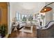 Bright living room featuring a fireplace, a grand piano, and large windows overlooking a serene view at 4222 Serenade Rd, Castle Rock, CO 80104