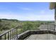 Charming patio featuring stone accents and wrought iron railing offering panoramic views of the surrounding landscape at 4222 Serenade Rd, Castle Rock, CO 80104