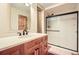 Bathroom featuring a sleek vanity with modern fixtures and a glass-enclosed shower at 4401 Sombrero Cir, Littleton, CO 80123