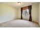 Bright bedroom with a large window and neutral carpet at 4401 Sombrero Cir, Littleton, CO 80123