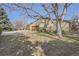 Well-manicured front lawn featuring beautiful landscaping, a driveway and a two-car garage at 4401 Sombrero Cir, Littleton, CO 80123