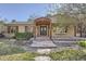 Charming home entrance with a covered porch, stone pathway, and landscaped garden at 4401 Sombrero Cir, Littleton, CO 80123