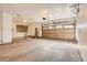 Spacious garage with overhead door, high ceilings, and ample room for storage at 4401 Sombrero Cir, Littleton, CO 80123
