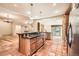 Bright kitchen with island cooktop, stainless appliances and tile flooring at 4401 Sombrero Cir, Littleton, CO 80123