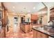 Spacious kitchen with stainless appliances, tile flooring and island cooktop at 4401 Sombrero Cir, Littleton, CO 80123