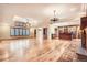 Open-concept home with hardwood floors, a fireplace, and a combined living/kitchen area at 4401 Sombrero Cir, Littleton, CO 80123