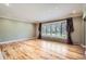 Bright and airy living room showcasing hardwood floors and a large bay window at 4401 Sombrero Cir, Littleton, CO 80123