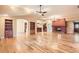 Spacious living room with hardwood floors, built-in shelves, and a fireplace at 4401 Sombrero Cir, Littleton, CO 80123