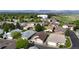 An aerial view of a well-maintained residential neighborhood with lush greenery and mountain views in the background at 23 Carla Way, Broomfield, CO 80020