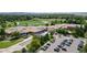 Aerial view of school with green playing fields and parking lot at 23 Carla Way, Broomfield, CO 80020
