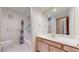 Bathroom features a large vanity with a sink and a shower-tub combo at 23 Carla Way, Broomfield, CO 80020