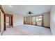 Spacious bedroom features a ceiling fan, connecting bath, and two windows with curtains at 23 Carla Way, Broomfield, CO 80020