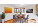 Cozy dining area features hardwood floors, corner windows, and modern art pieces at 23 Carla Way, Broomfield, CO 80020